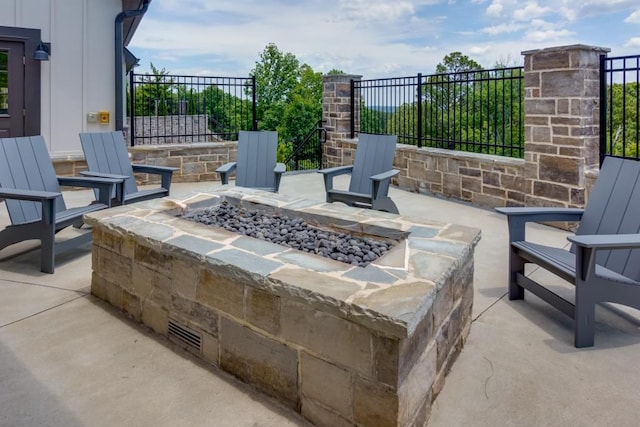 view of patio / terrace featuring an outdoor fire pit