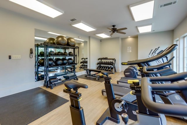 gym with ceiling fan and hardwood / wood-style floors