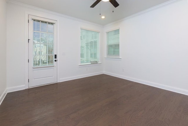 spare room with dark wood-type flooring, ceiling fan, and ornamental molding