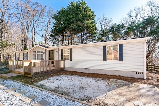 manufactured / mobile home featuring crawl space and a deck