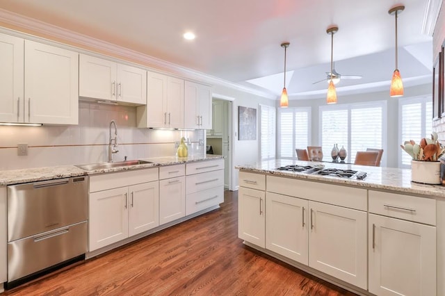 kitchen with white cabinets, a wealth of natural light, stainless steel appliances, and a sink