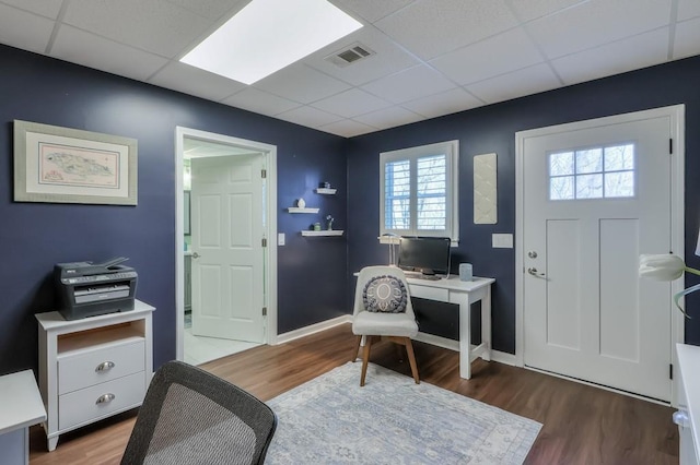 entryway with visible vents, a drop ceiling, and wood finished floors