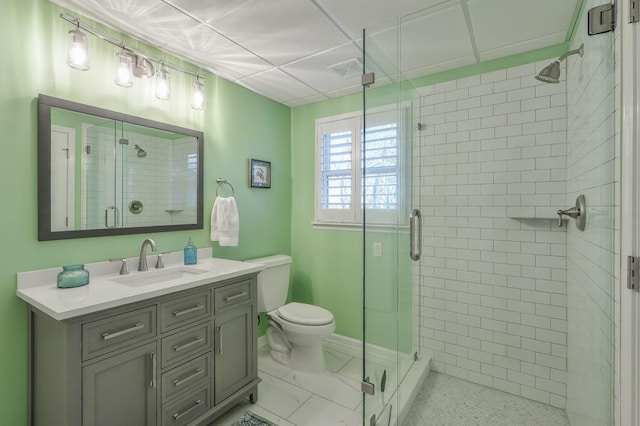 bathroom with toilet, a shower stall, visible vents, and vanity