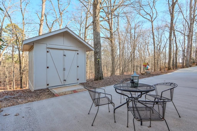 view of patio with a shed and an outdoor structure