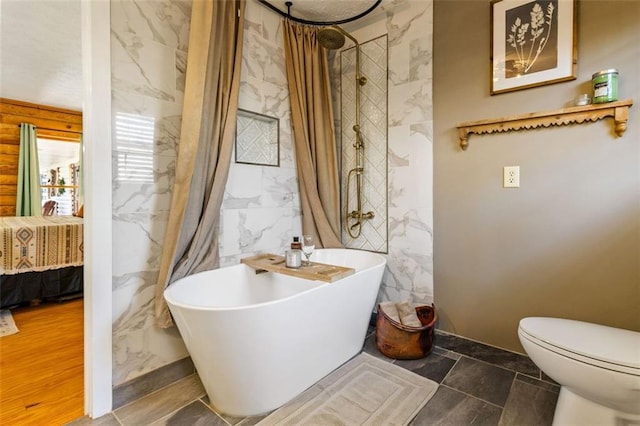 bathroom featuring toilet, tile walls, and plus walk in shower