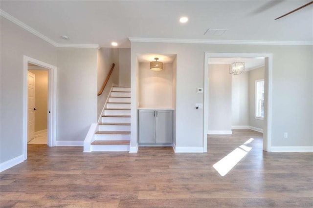 interior space with hardwood / wood-style flooring and ornamental molding