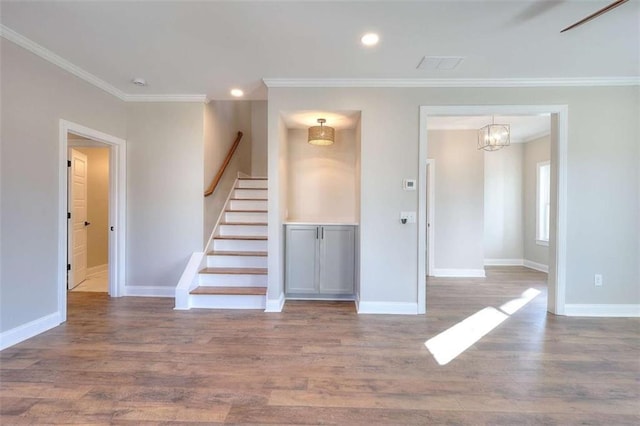 interior space with hardwood / wood-style flooring and ornamental molding