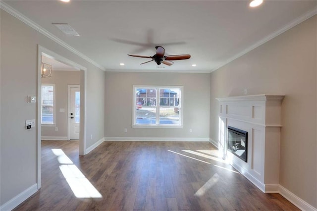 unfurnished living room with crown molding, dark hardwood / wood-style flooring, and a wealth of natural light