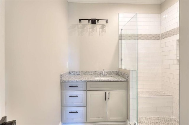 bathroom with vanity and a tile shower