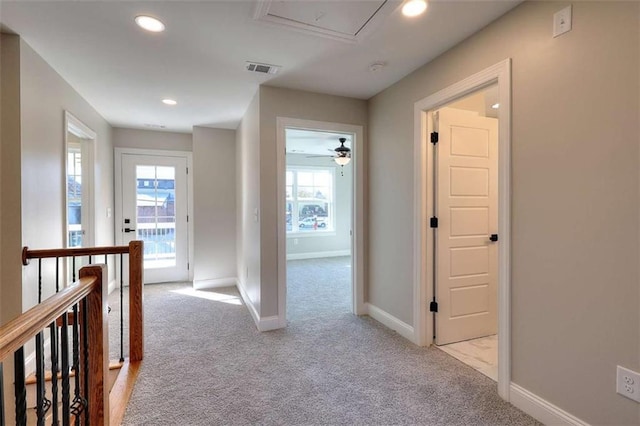 corridor with light colored carpet