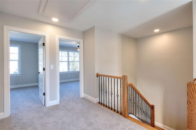 hallway with light colored carpet