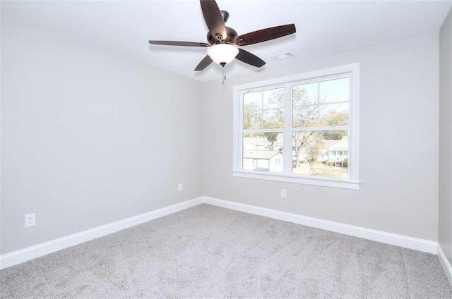 spare room featuring carpet floors and ceiling fan