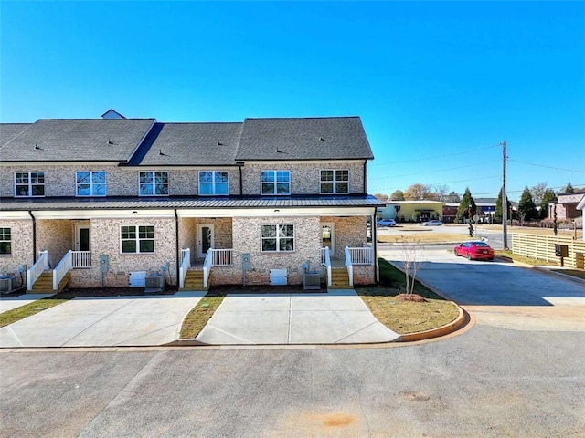 back of property featuring central AC unit and covered porch