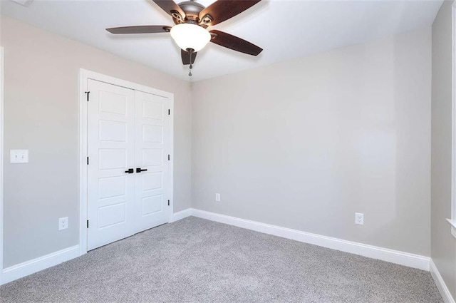 unfurnished bedroom featuring a closet, ceiling fan, and carpet