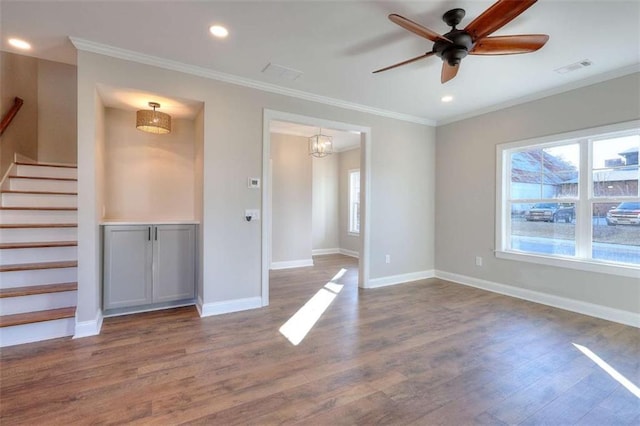 spare room with wood-type flooring, ceiling fan, and crown molding