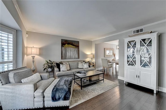 living room featuring dark wood finished floors, crown molding, baseboards, and visible vents