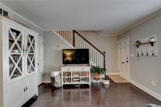 living room with stairway, wood finished floors, baseboards, and ornamental molding