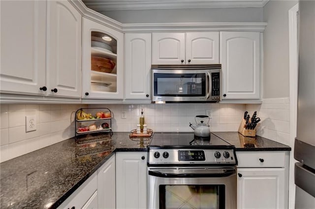 kitchen featuring stainless steel appliances, tasteful backsplash, crown molding, and white cabinetry