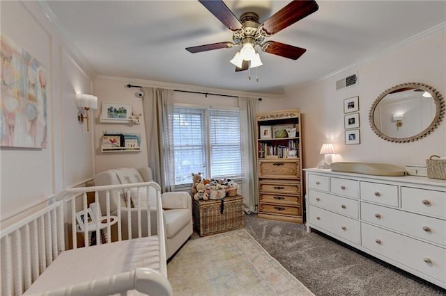 bedroom featuring visible vents, ceiling fan, carpet, ornamental molding, and a nursery area