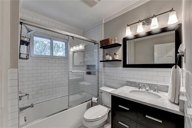 full bath with toilet, ornamental molding, tile walls, enclosed tub / shower combo, and vanity