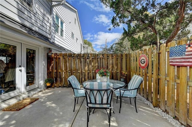 view of patio / terrace featuring outdoor dining area, fence, and french doors