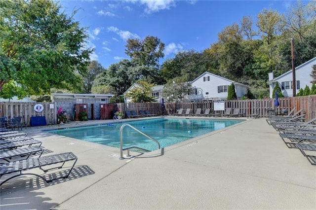 community pool featuring a patio area and fence