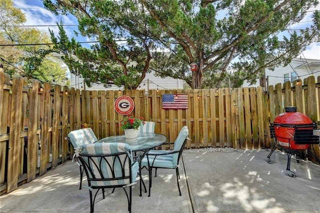 view of patio / terrace with area for grilling, outdoor dining area, and a fenced backyard