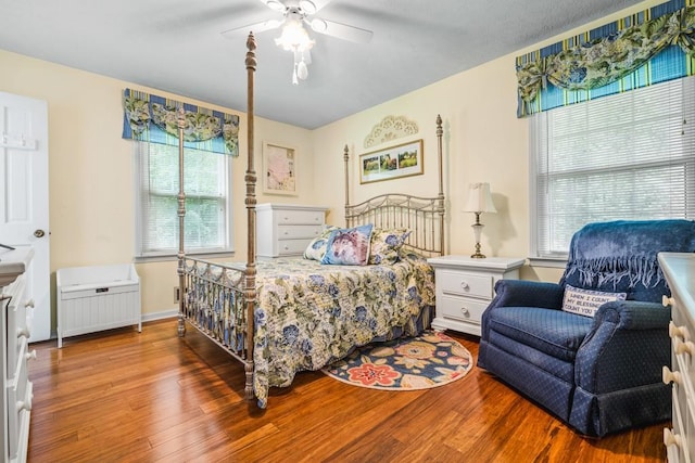 bedroom with ceiling fan and wood-type flooring