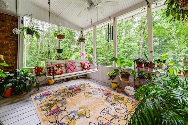 unfurnished sunroom with a wealth of natural light, ceiling fan, and lofted ceiling