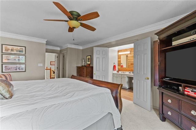 bedroom featuring a ceiling fan, ensuite bath, ornamental molding, and light carpet