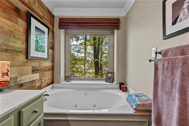 full bath featuring a jetted tub, vanity, and ornamental molding