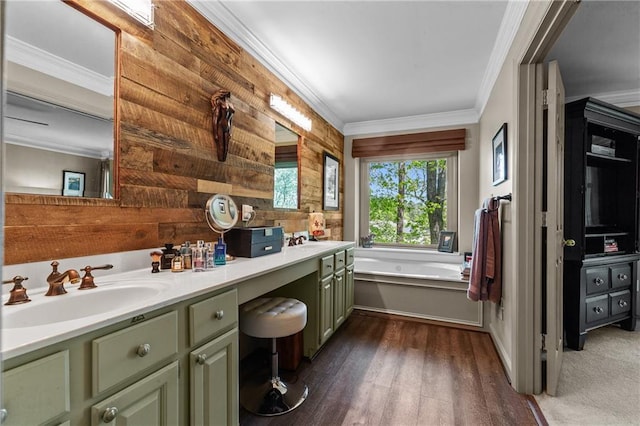bathroom featuring a bath, a sink, double vanity, and crown molding