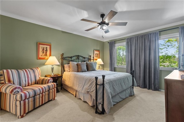 bedroom with a ceiling fan, light colored carpet, and crown molding