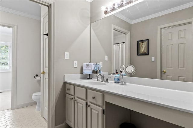 bathroom with baseboards, vanity, ornamental molding, and toilet