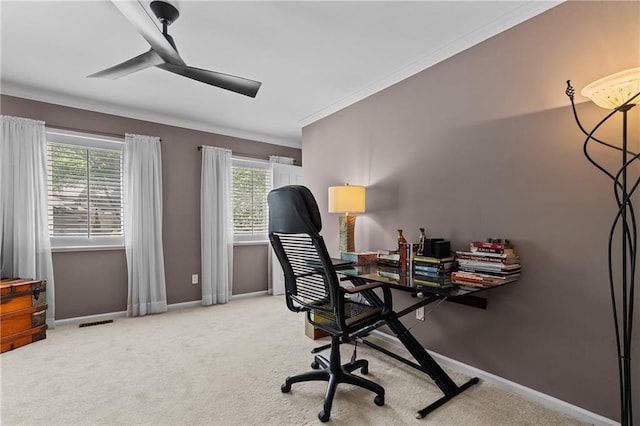 carpeted office with visible vents, a ceiling fan, baseboards, and ornamental molding