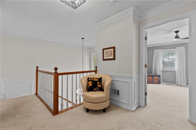 sitting room featuring visible vents, a wainscoted wall, carpet flooring, and crown molding