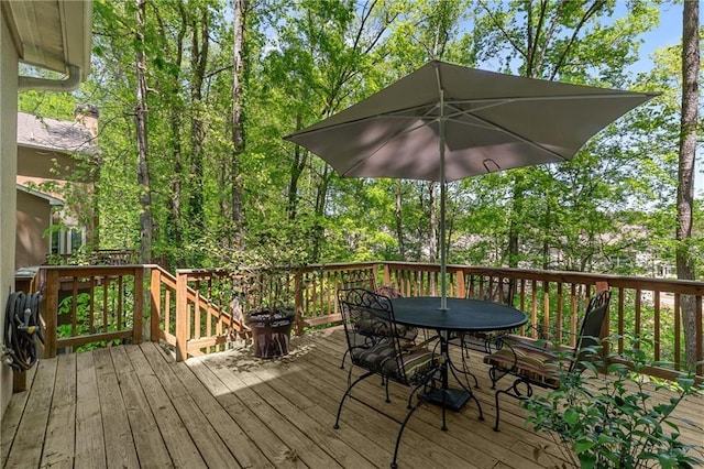 wooden deck featuring outdoor dining area