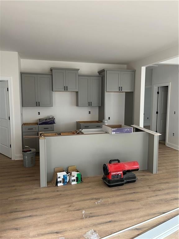 kitchen with gray cabinets and light wood-type flooring