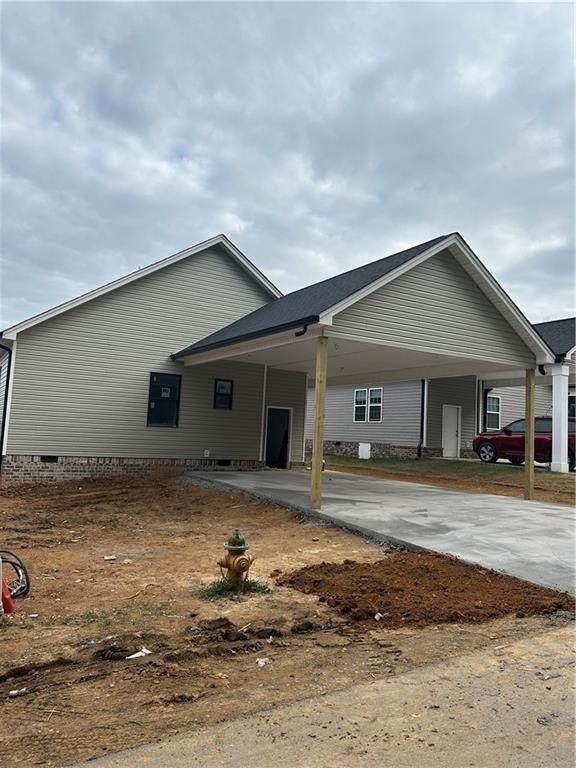 back of property with a carport