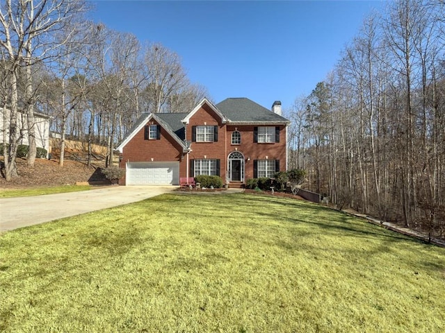 colonial inspired home featuring concrete driveway, brick siding, a chimney, and a front lawn