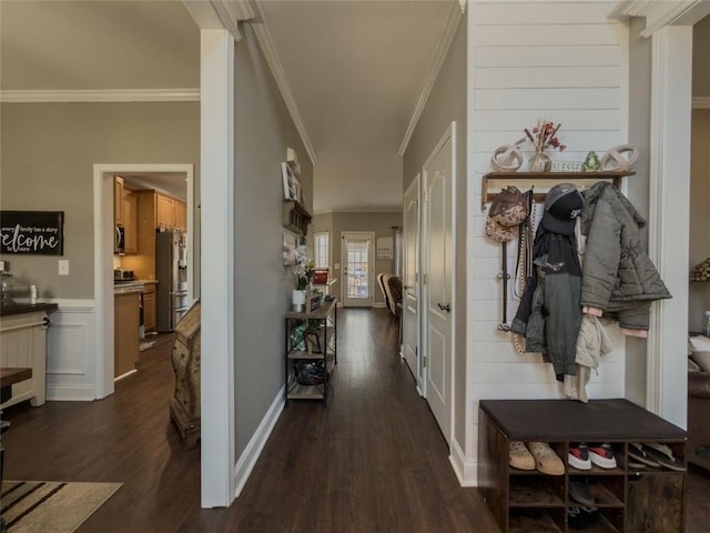 interior space with dark wood-style floors, ornamental molding, and baseboards