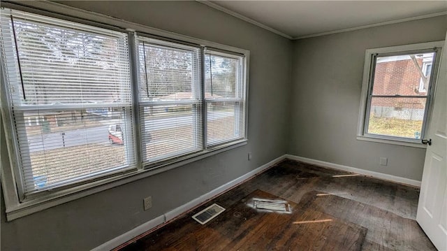 unfurnished room featuring baseboards, visible vents, and crown molding