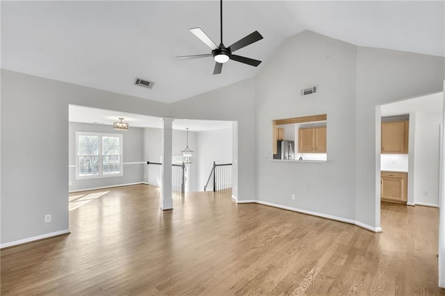 unfurnished living room with light wood-style floors, baseboards, and visible vents