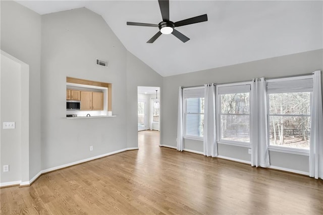 unfurnished living room featuring high vaulted ceiling, ceiling fan, baseboards, and wood finished floors