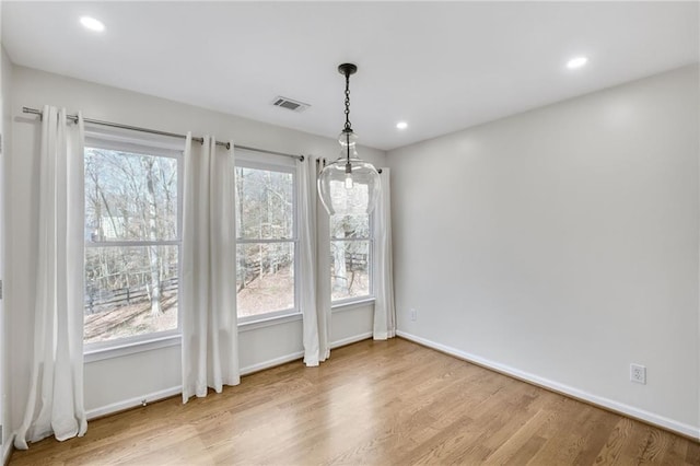 unfurnished dining area featuring recessed lighting, visible vents, plenty of natural light, and wood finished floors