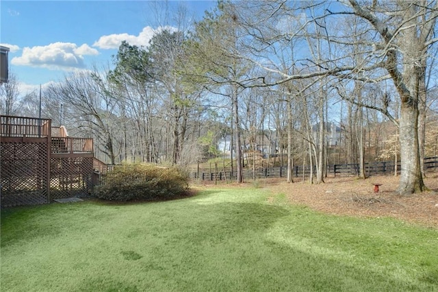 view of yard with stairs, fence, and a deck