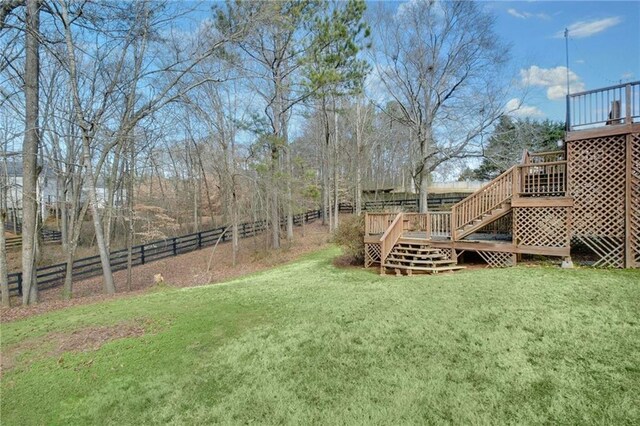 view of yard with stairway, fence, and a deck