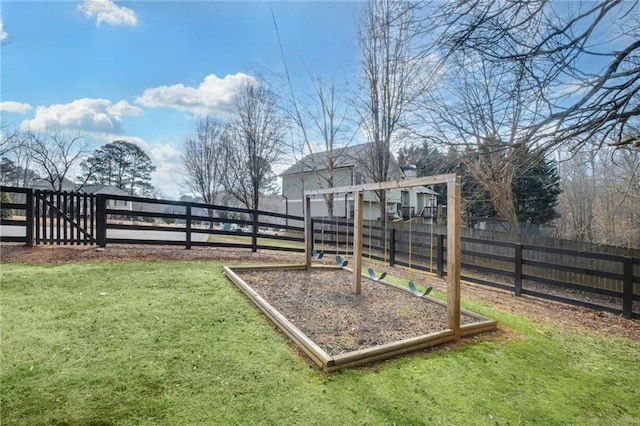 view of playground with a lawn and fence