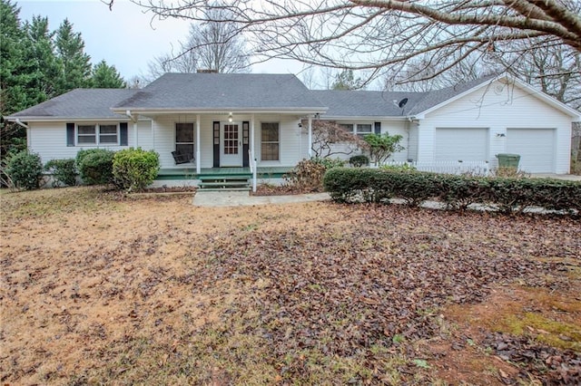 ranch-style house with a porch and a garage