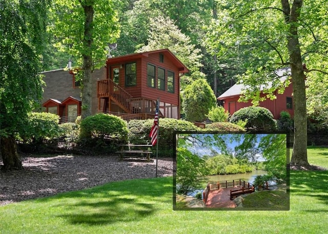 view of play area with a yard and a water view